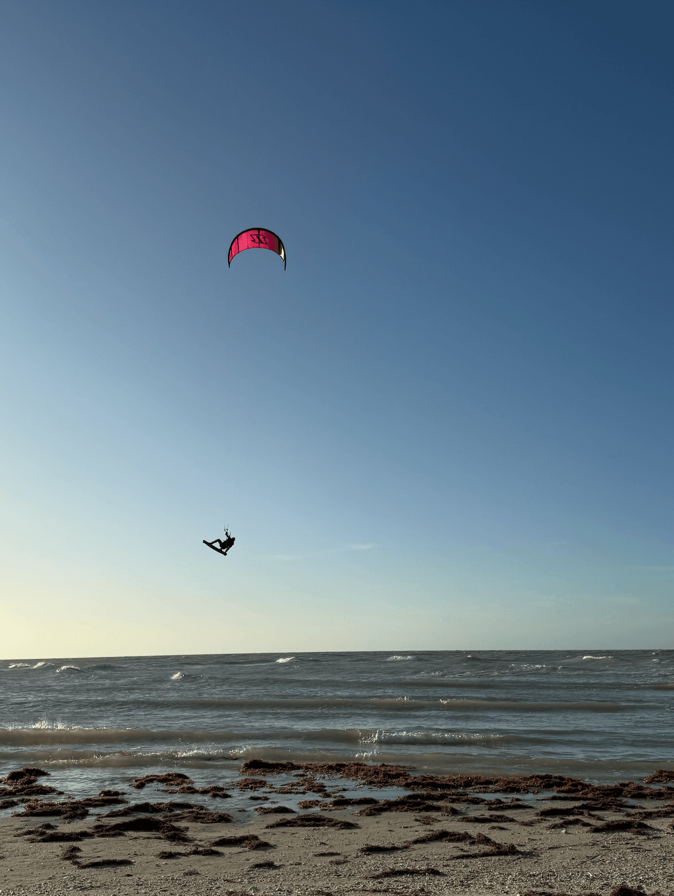 A kitesurfer flying above the waves near Progreso